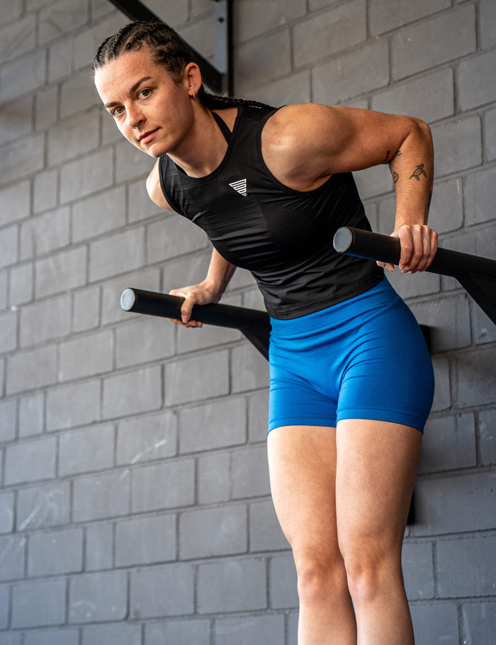 GORNATION athlete performing dips on GORNATION dip bars wearing the active tank top