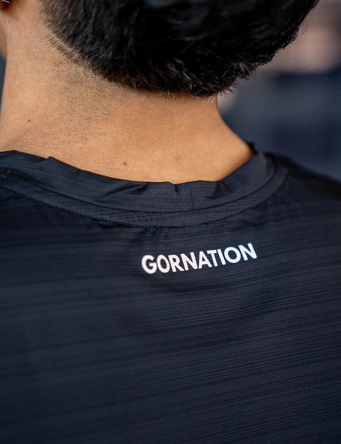 Close up of a GORNATION athlete wearing the GORNATION active tank top in black