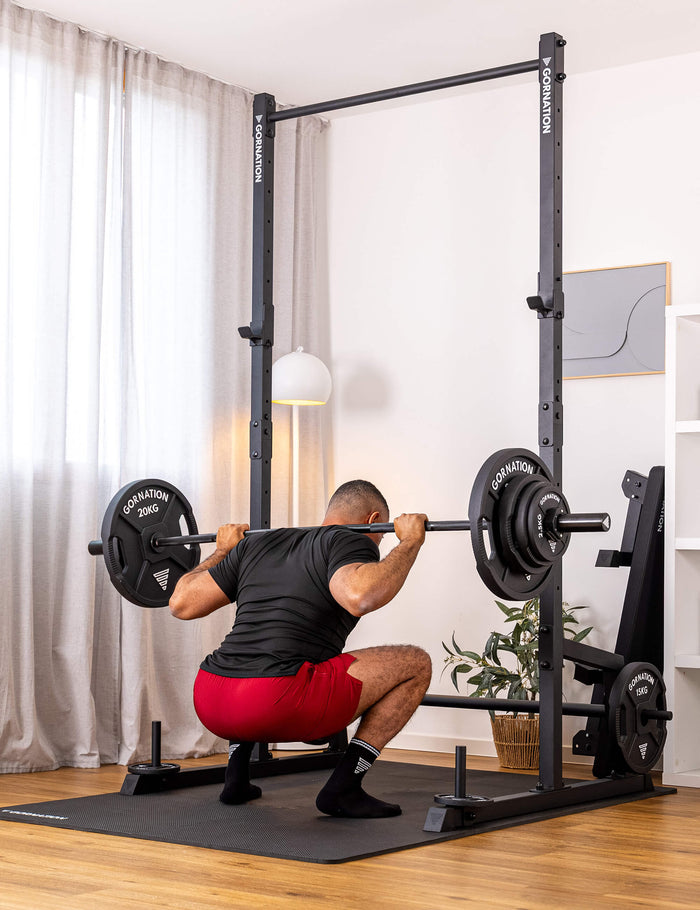 GORNATION athlete performing squats with a GORNATION barbell
