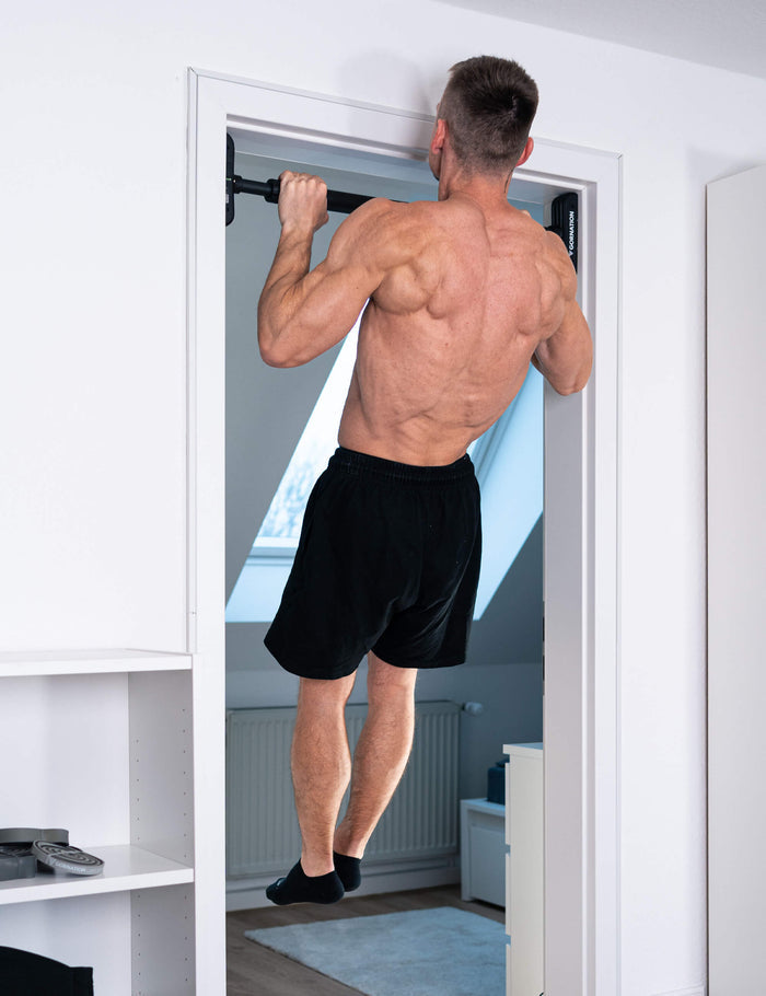 GORNATION athlete performing pull ups on the door pull up bar Extend-It