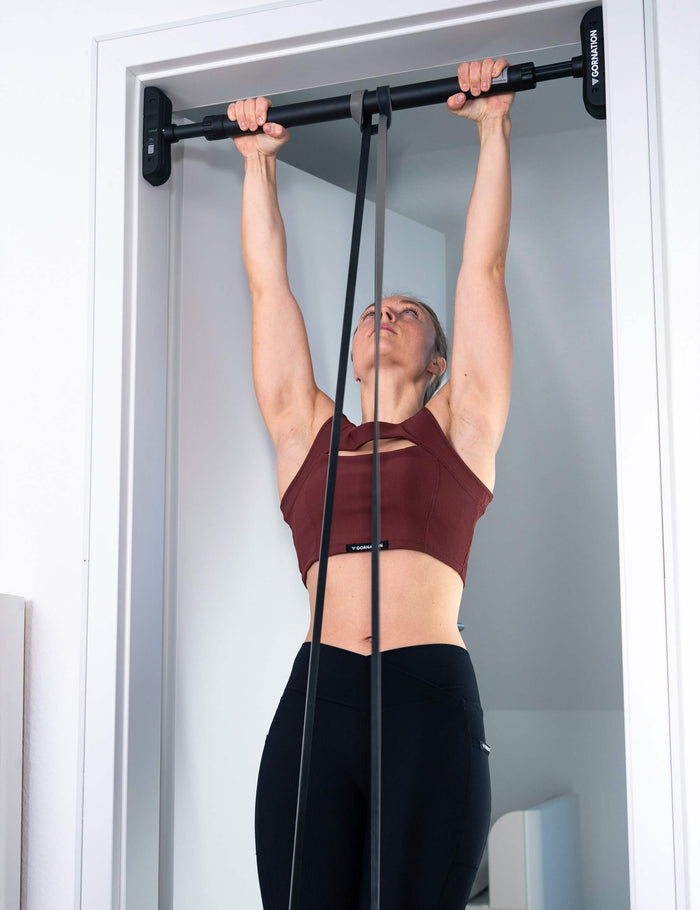 GORNATION athlete performing assisted pull ups on the door pull up bar Extend-It