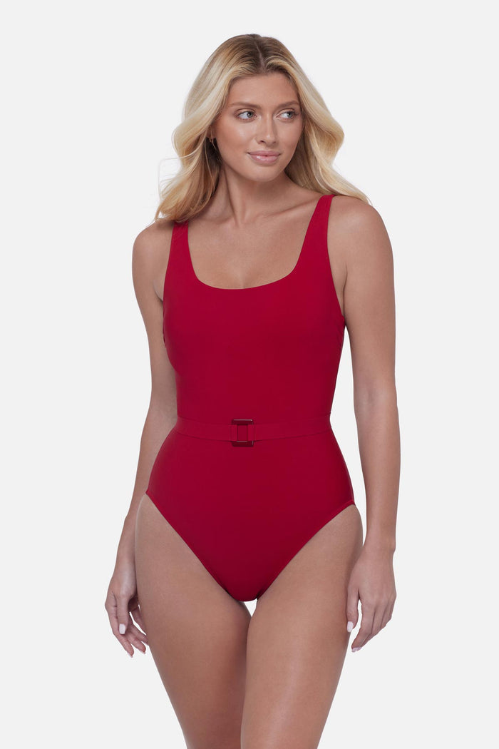 Woman wearing a cherry red one-piece swimsuit with belt