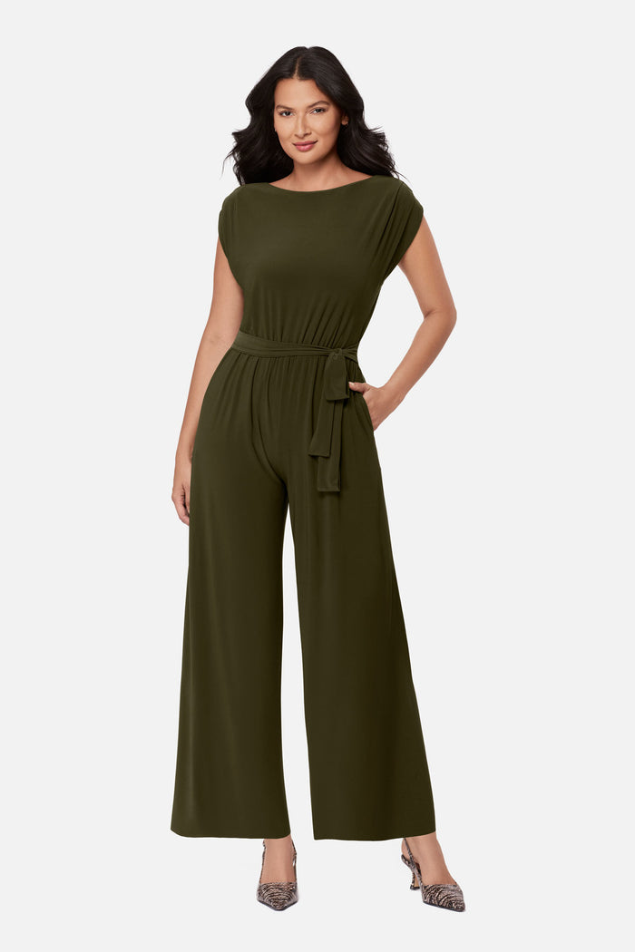 Woman wearing a green romper with a sash around the waist