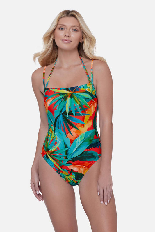 Woman wearing a bright multicolored palm leaf printed one-piece swimsuit with double straps