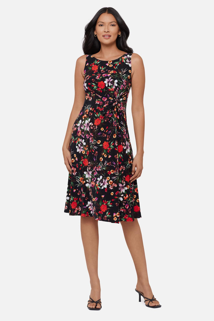 Woman wearing a multicolored floral printed sleeveless mid length dress