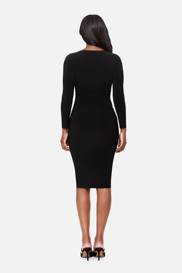 Woman turned away wearing a long sleeve black dress