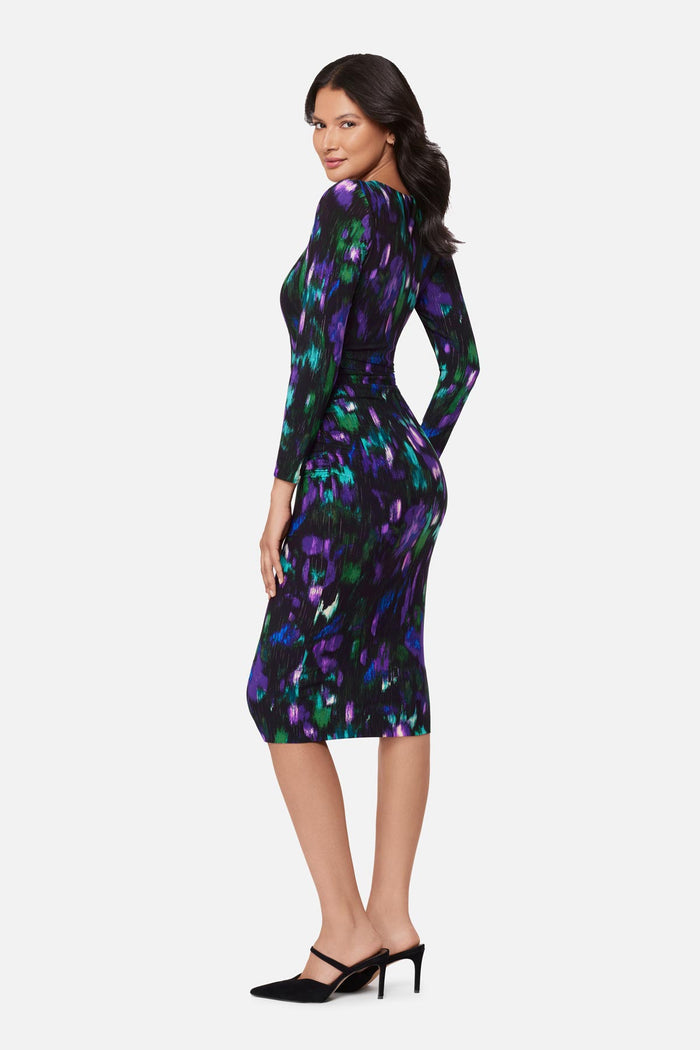 Woman turned left wearing a multicolored print long sleeve dress
