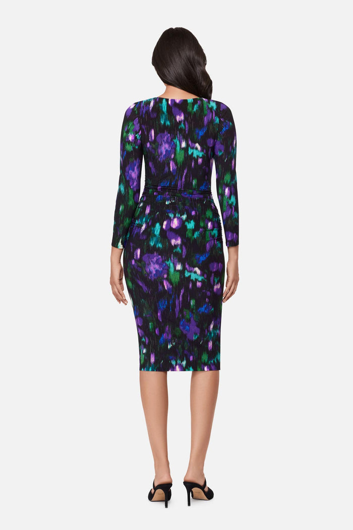 Woman turned away wearing a multicolored print long sleeve dress