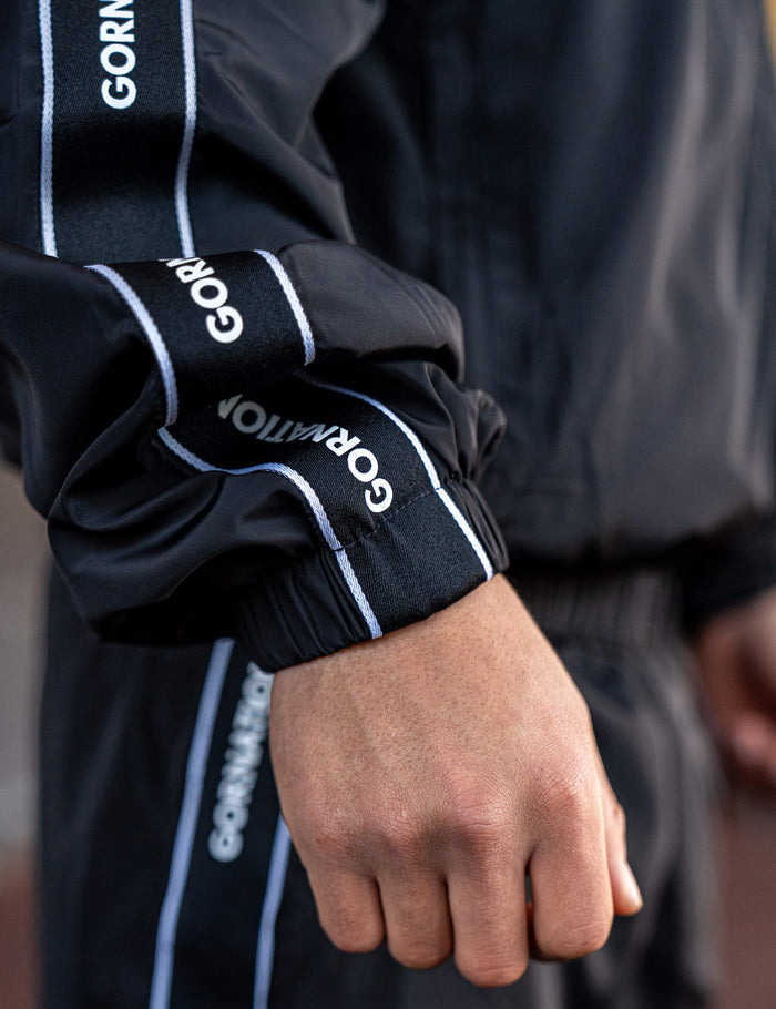 Close up of a GORNATION athlete wearing the GORNATION tracksuite jacket in black