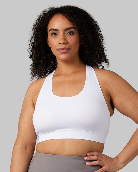 32 Degrees White _ Women's Seamless Racberback Sports Bra {model: Maria is 5'9" and size 14, wearing size L}{bottom}{right}