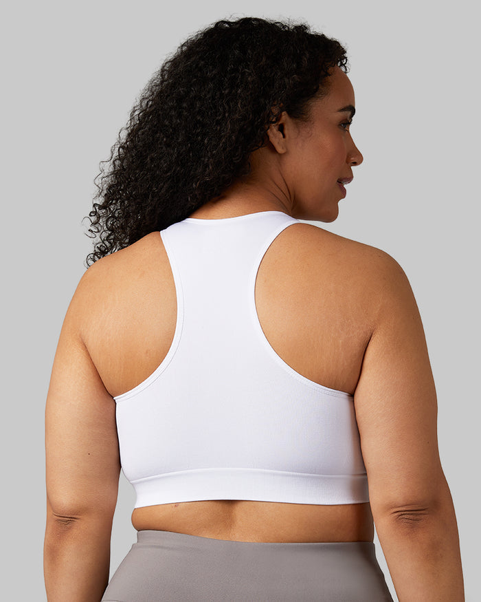 32 Degrees White _ Women's Seamless Racberback Sports Bra {model: Maria is 5'9" and size 14, wearing size L}{bottom}{right}